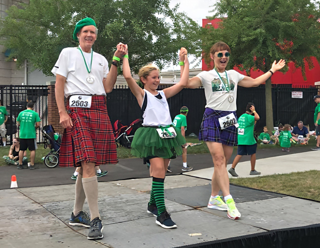 Tom and Mary Kay Aufrance winning medals and jig dancing at Irish Fest 5K